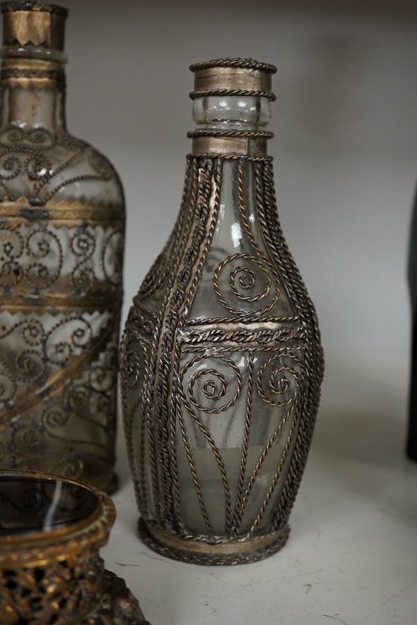 A collection of continental glass and wire worked bottles and flasks and a gilt metal onyx trinket box, tallest 19.5cm